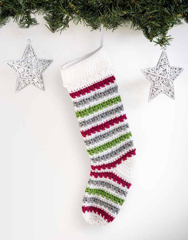 Add some Christmas cheer to your mantle with this free crochet Christmas stocking pattern. The stunning stripped design can be easily made in only two days.