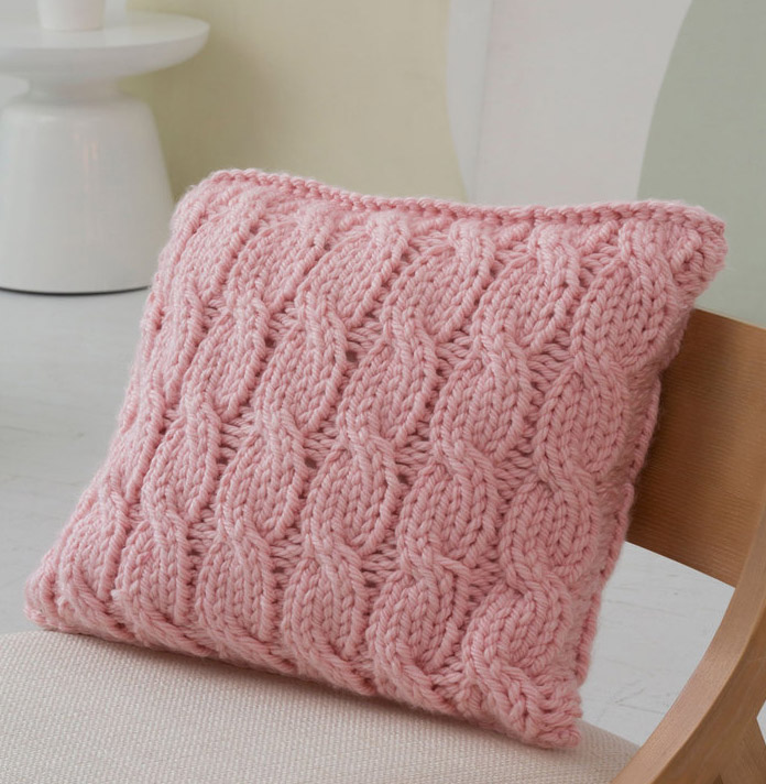 Big Cables Pillow - We’ve gathered here 10 of the easiest patterns for first-time knitters to tackle that most fascinating of knitting wonders - cables! #cableknitting #cableknits #knittingpatterns