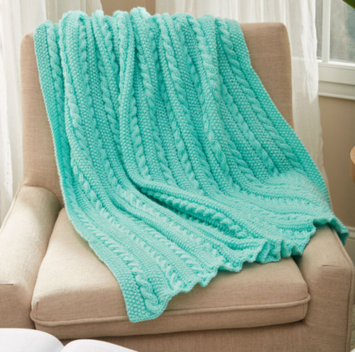 Easy Cable Knit Blanket - We’ve gathered here 10 of the easiest patterns for first-time knitters to tackle that most fascinating of knitting wonders - cables! #cableknitting #cableknits #knittingpatterns