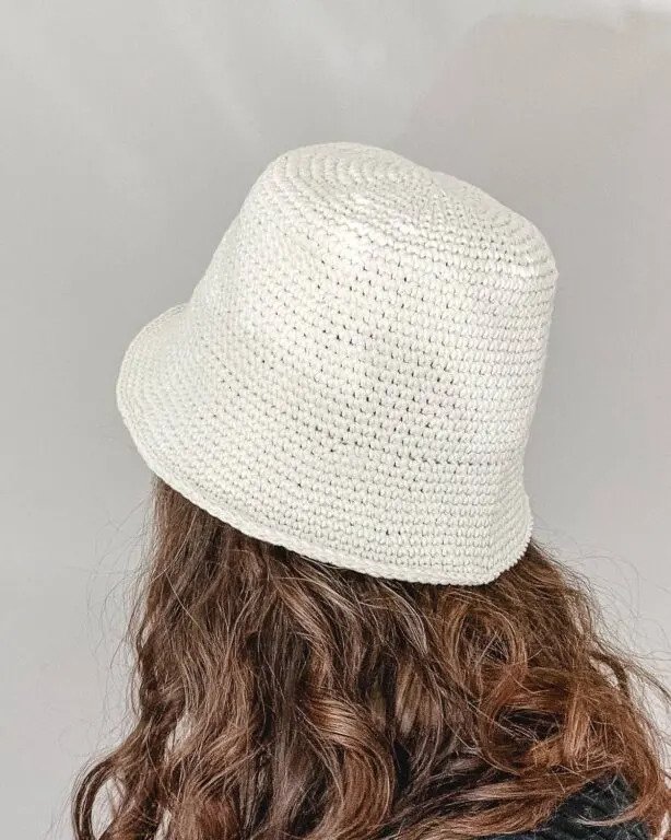 A girl wearing a white crochet bucket hat