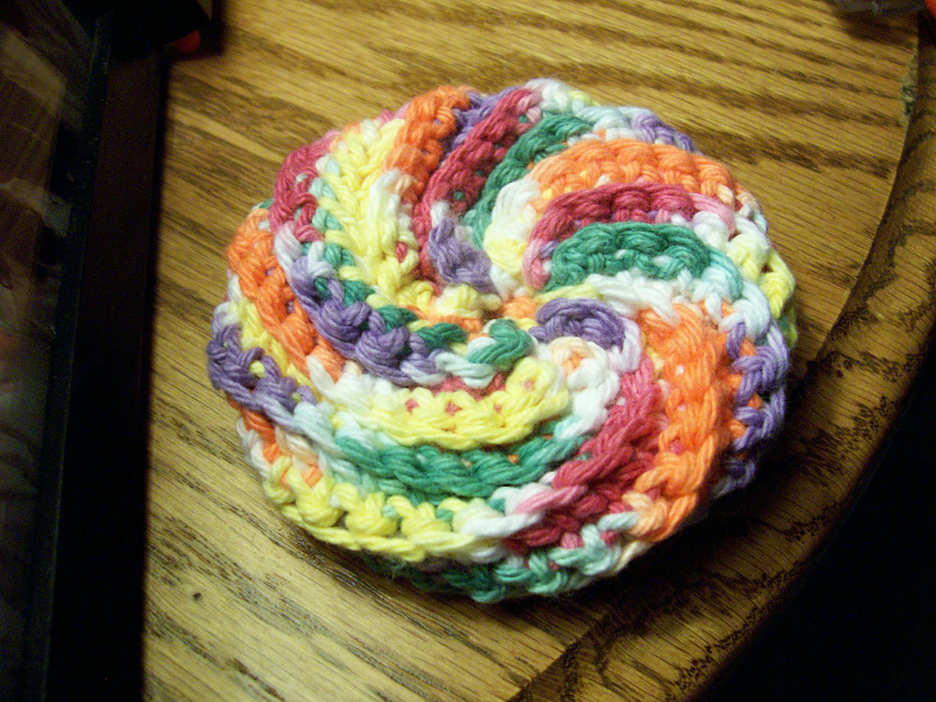Crochet Spiral Scrubbie on a wooden table