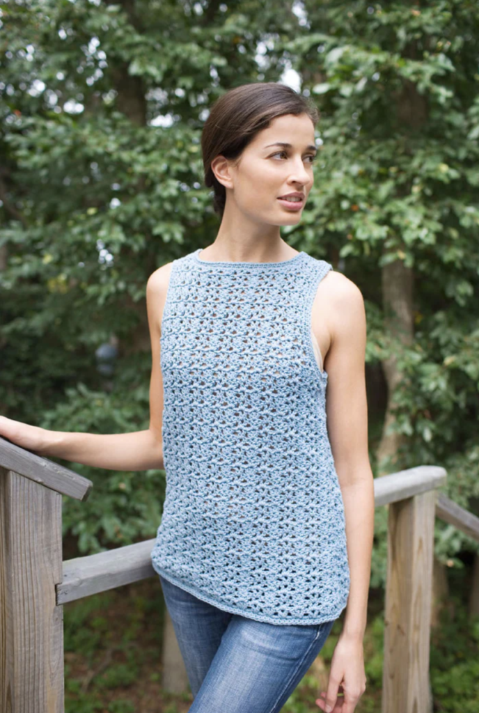 a woman wearing an airy lace shell crochet top