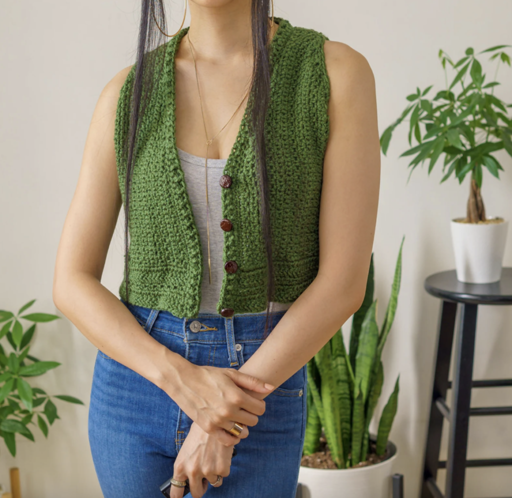 a woman wearing a classic crochet vest