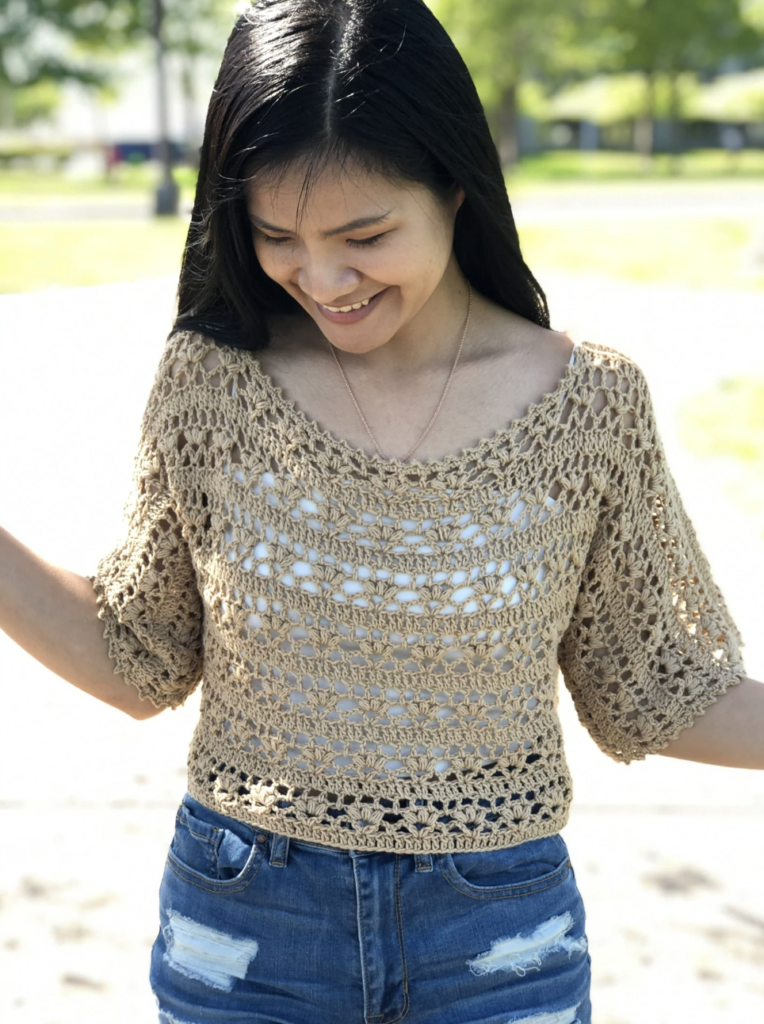 a woman wearing a crochet lacy summer top