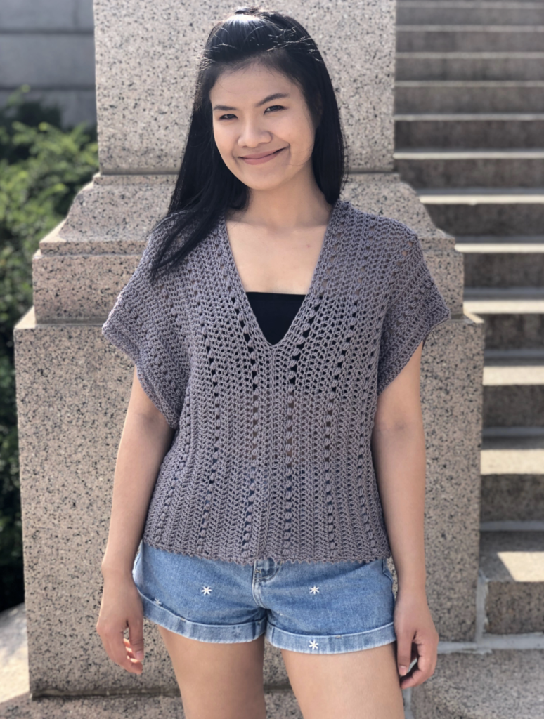 a girl wearing a crochet v-neck summer blouse