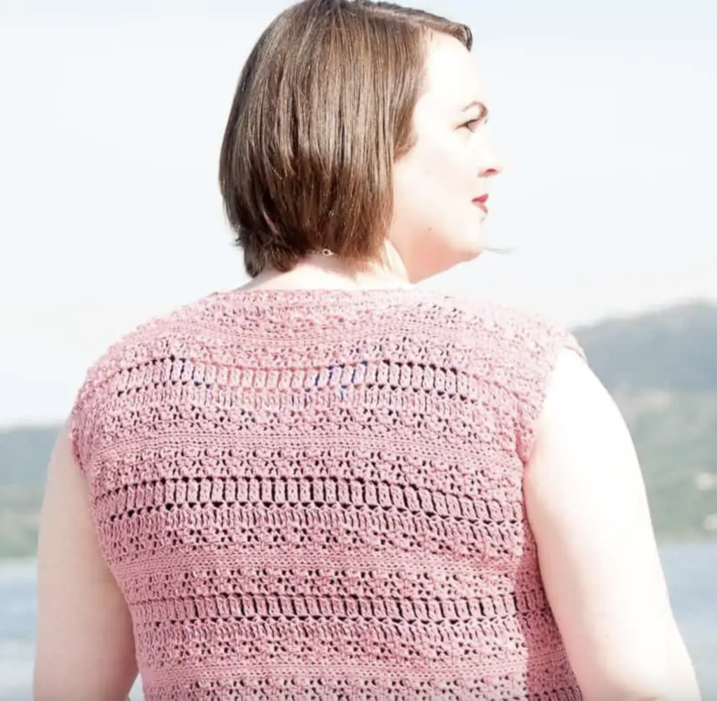 a woman wearing a crochet summer top