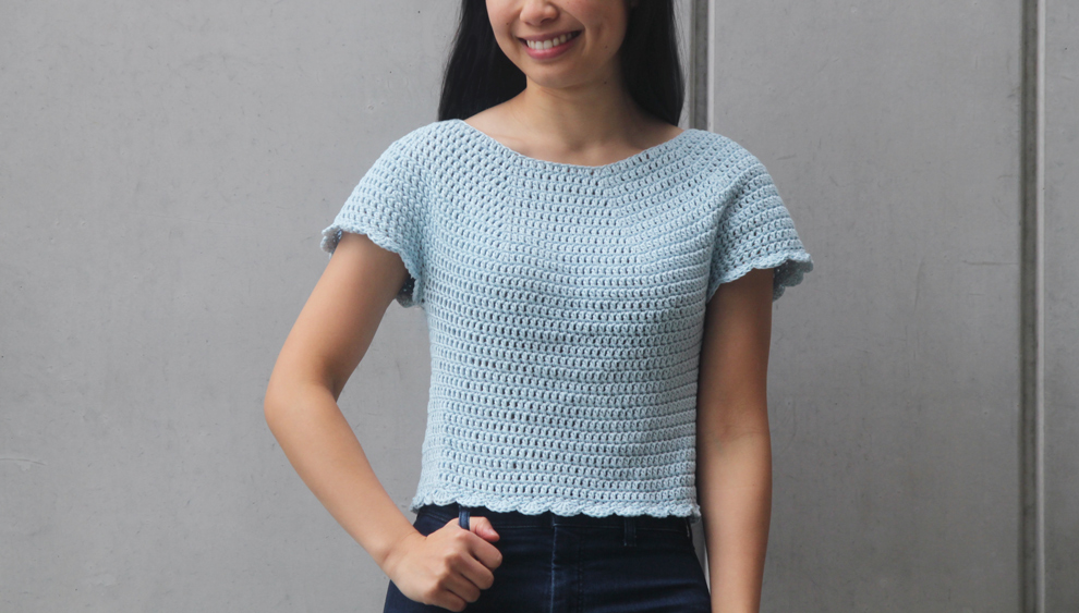 A girl wearing a crochet scallop top
