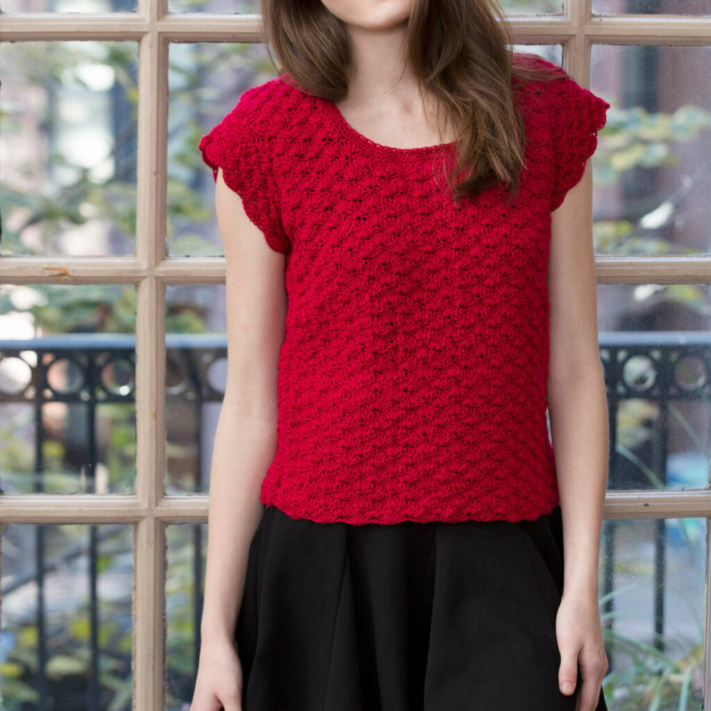 a woman wearing the Red Heart Shell Stitch Crochet Top