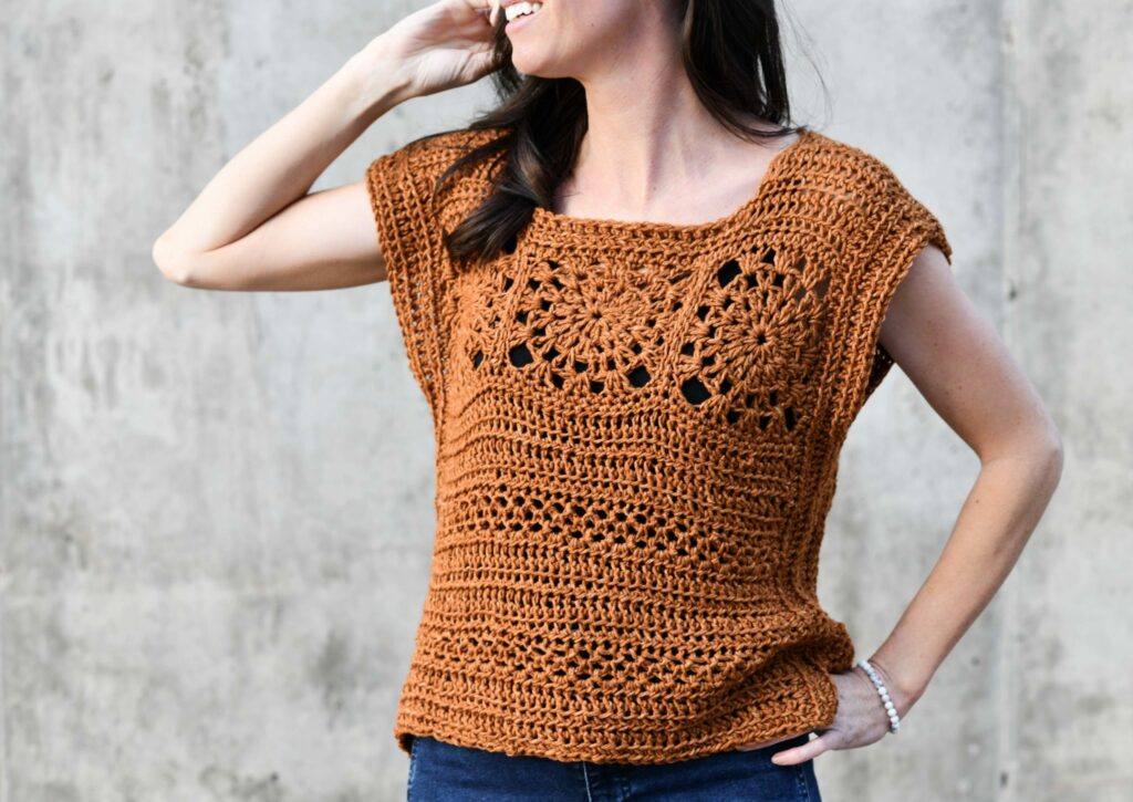 a woman wearing a boho crochet top
