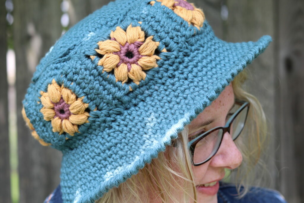A girl wearing a glasses and the Garden Crochet Bucket Hat