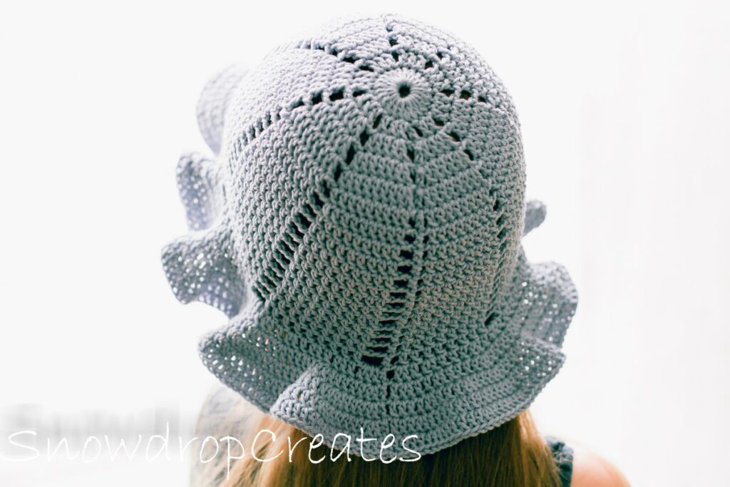 The Lilac Sun Crochet Hat on a kid's head