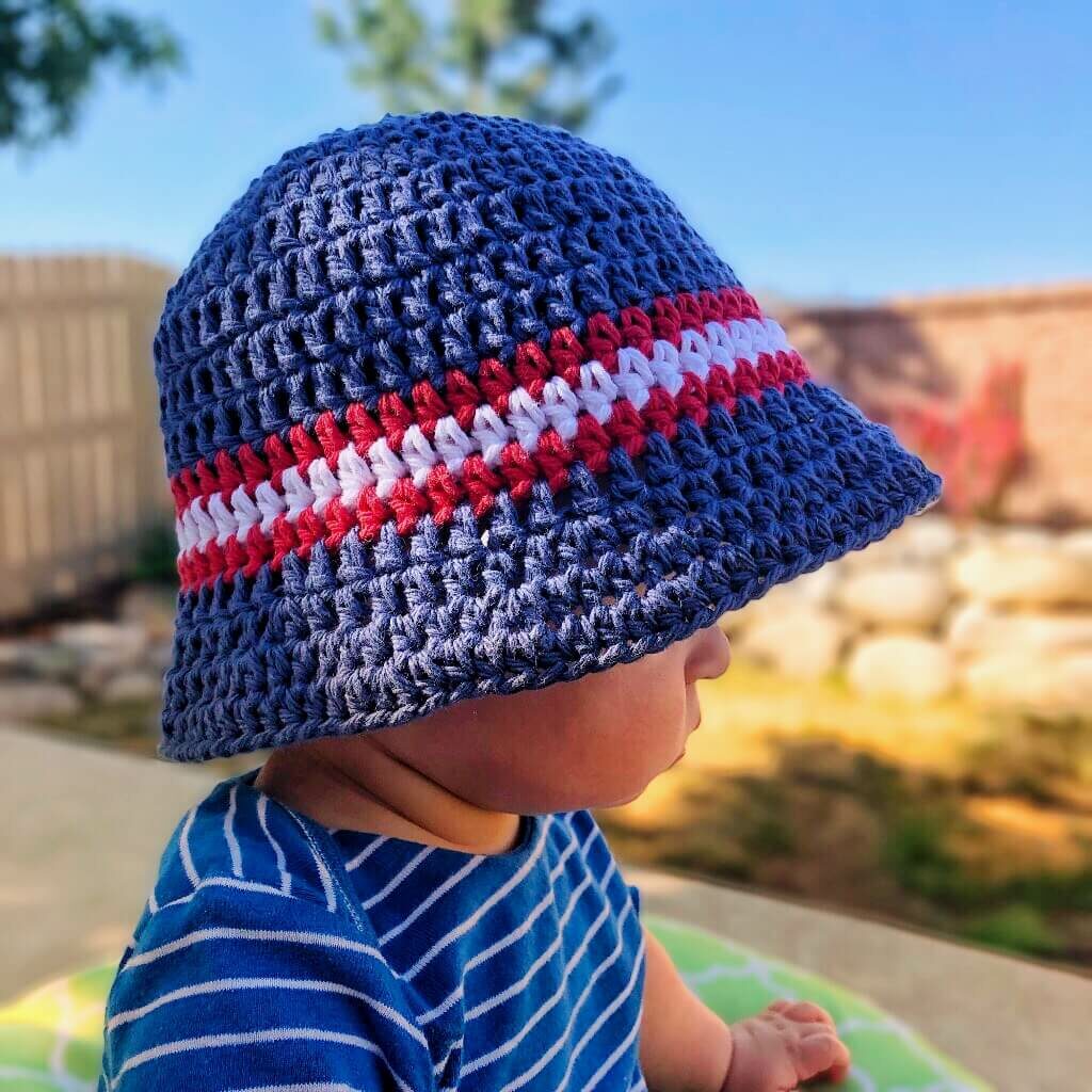 a kid wearing a crochet bucket hat