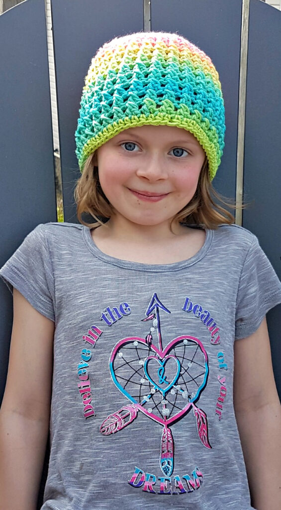 a girl wearing double crossed crochet hat