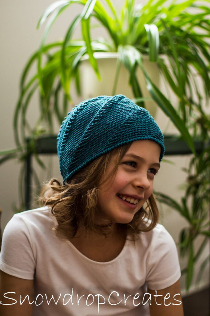 a girl wearing a livia crochet hat