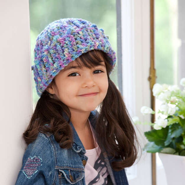 a girl wearing a cuffed crochet hat