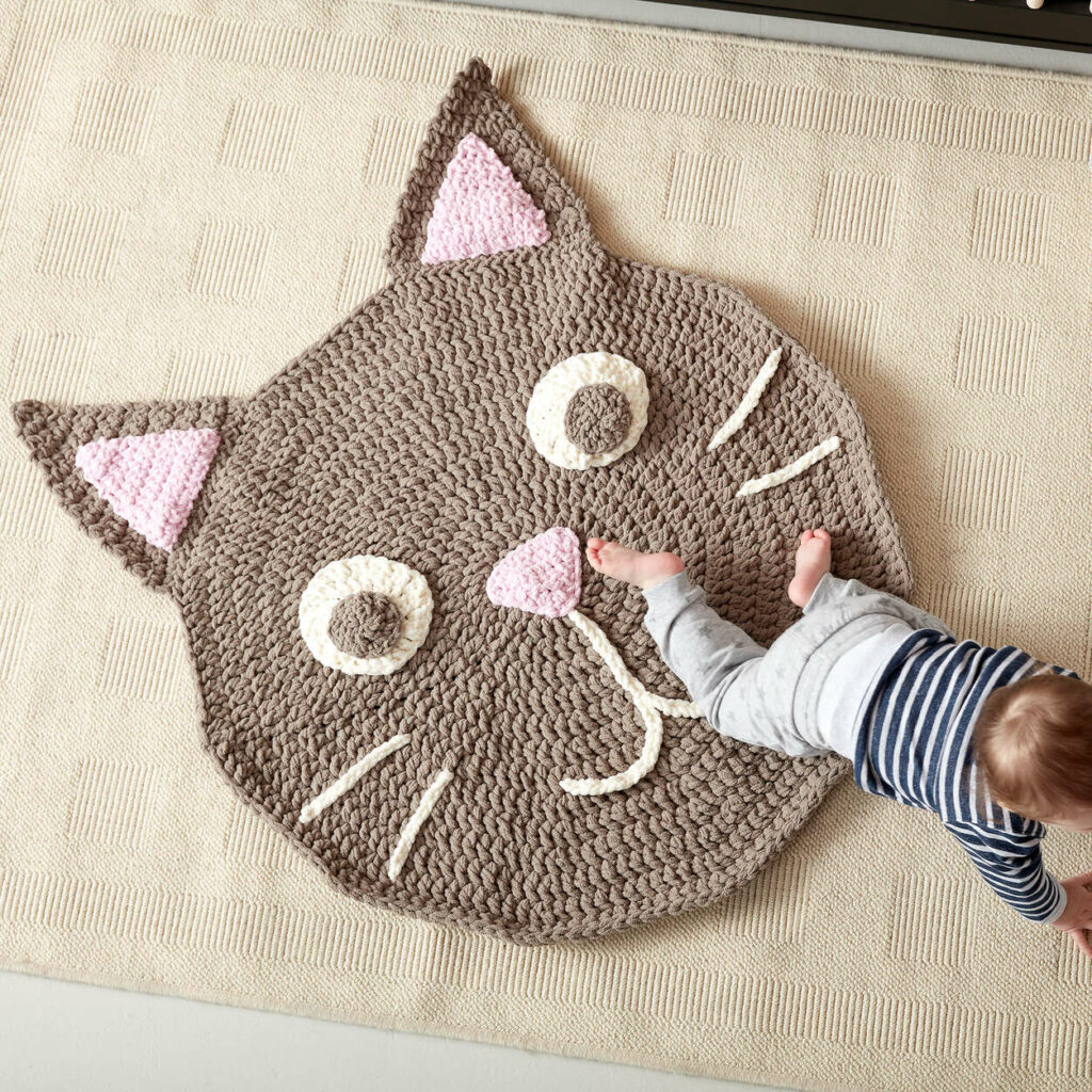 bernat purrrfect crochet cat play rug and baby on it