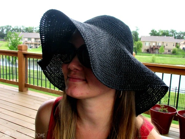 Woman wearing floppy sun hat crochet
