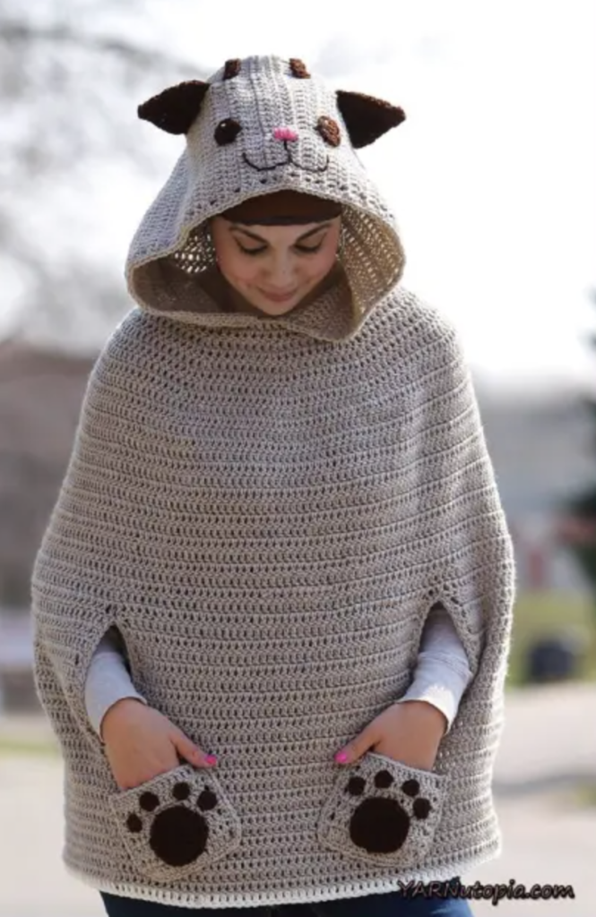 woman wearing crochet cat poncho