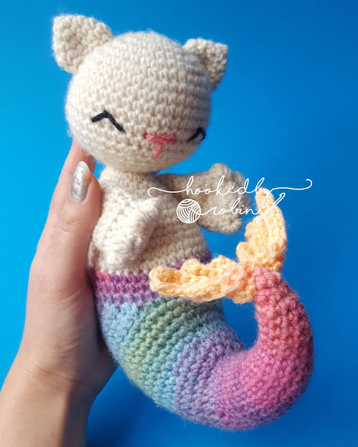 a person holding purrmaid the mermaid crochet cat