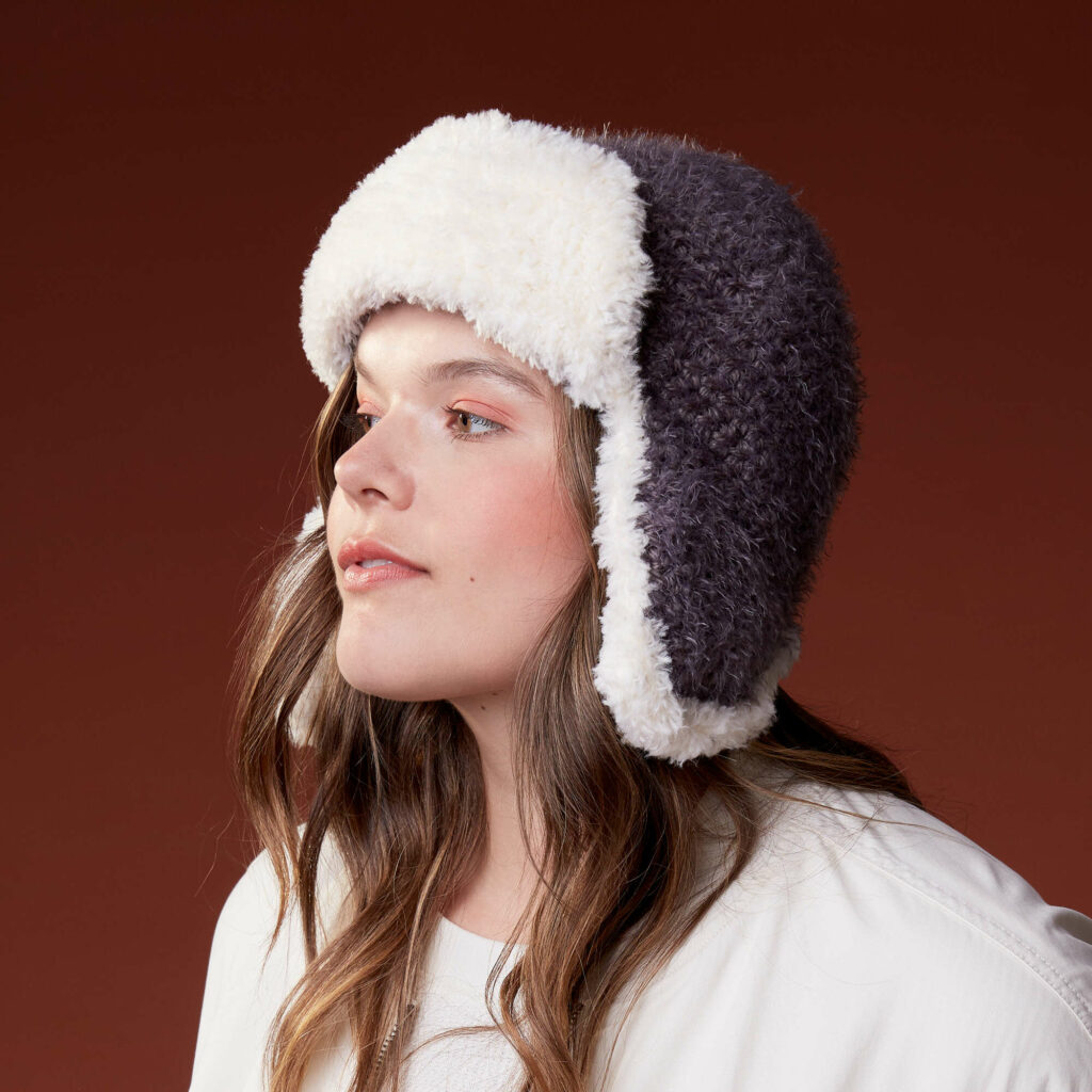 woman wearing cozy trapper hat crochet
